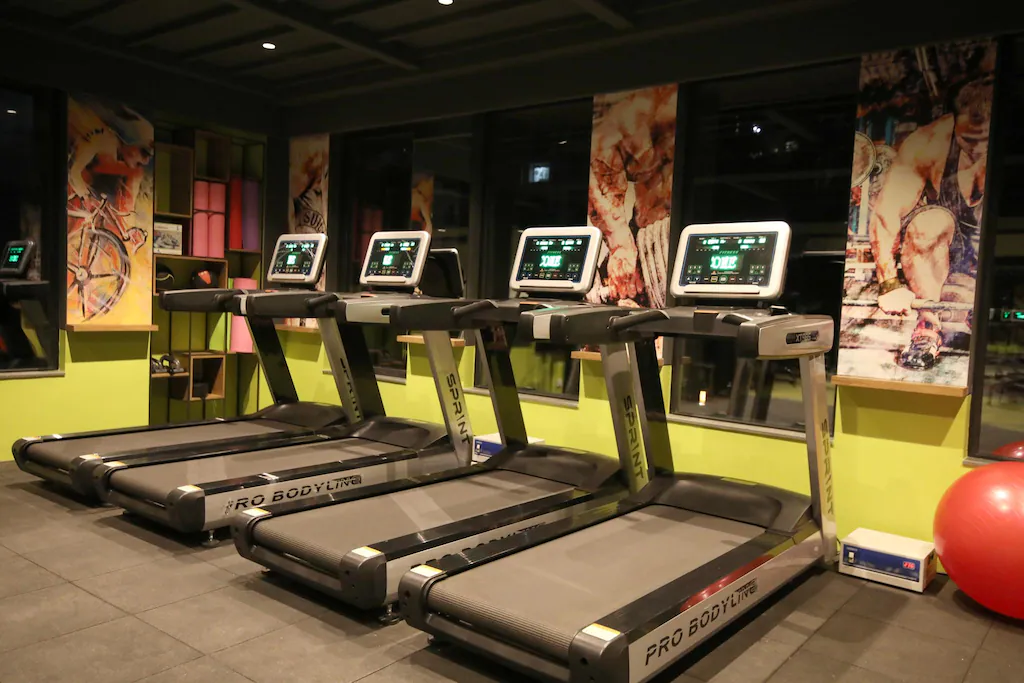 Modern fitness center with equipment and large windows